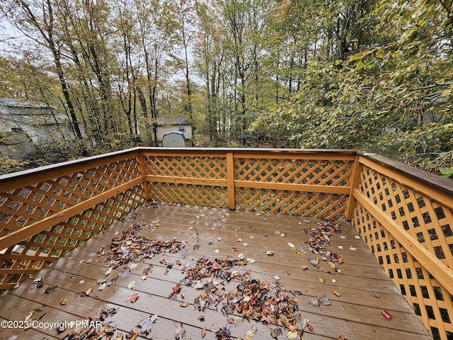 wooden deck with a shed and an outdoor structure