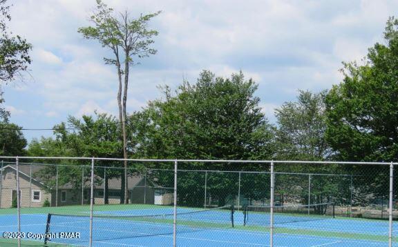 view of sport court featuring fence