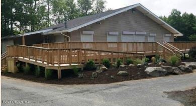 rear view of property with a wooden deck