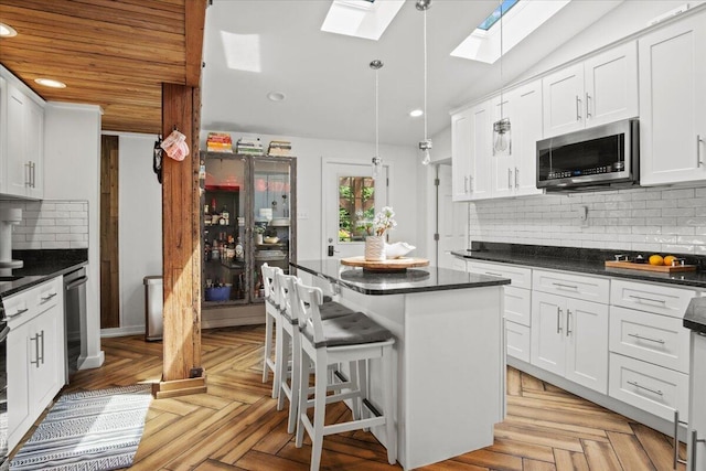 262 Marilou Ln, Bartonsville, PA 18321 - kitchen with stainless steel microwave, a skylight, dark countertops, and recessed lighting