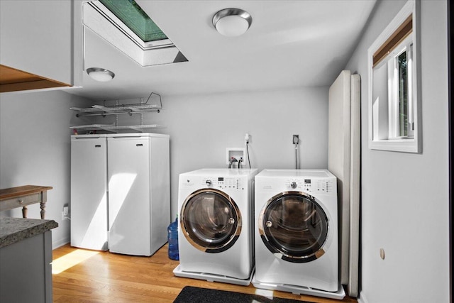 262 Marilou Ln, Bartonsville, PA 18321 - laundry area with separate washer and dryer, cabinet space, light wood-type flooring, and a skylight