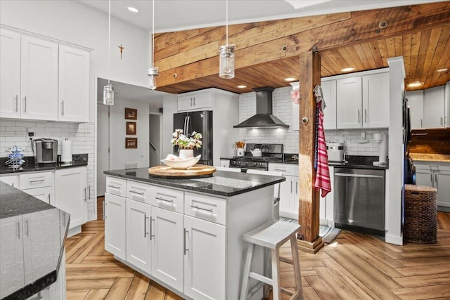 262 Marilou Ln, Bartonsville, PA 18321 - kitchen with stainless steel appliances, wall chimney exhaust hood, decorative backsplash, white cabinetry, and recessed lighting