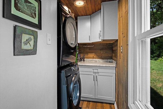 262 Marilou Ln, Bartonsville, PA 18321 - laundry area featuring estacked washer and dryer, cabinet space, wood ceiling, and wood finished floors