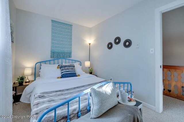 bedroom featuring carpet flooring and baseboards