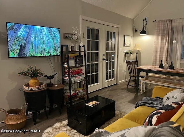 living area featuring french doors and vaulted ceiling