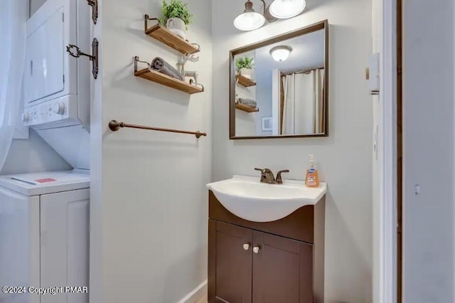 bathroom with stacked washer / drying machine and vanity