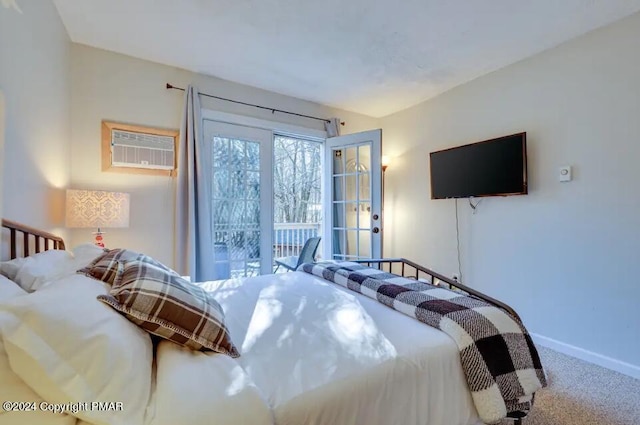 bedroom with carpet floors, access to outside, a wall mounted air conditioner, and baseboards