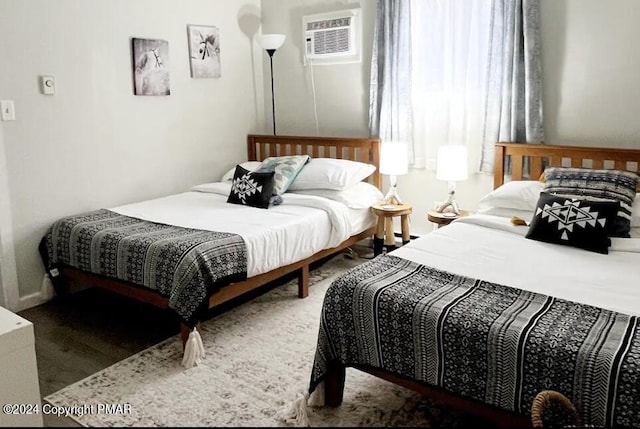 bedroom featuring a wall mounted AC