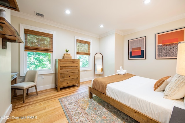 bedroom with visible vents, baseboards, ornamental molding, light wood-style floors, and recessed lighting