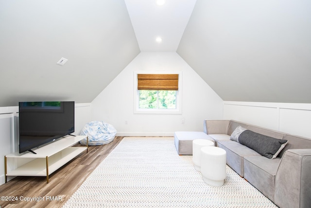 living area featuring lofted ceiling and wood finished floors