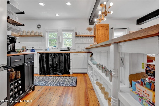 kitchen featuring light wood-style flooring, white dishwasher, open shelves, and beamed ceiling