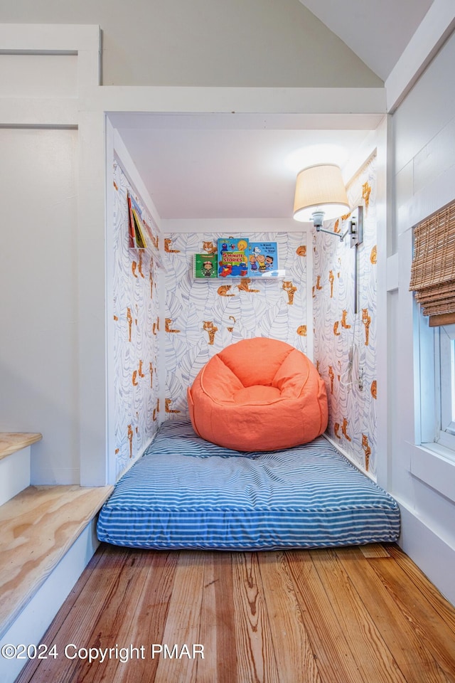 bedroom featuring lofted ceiling and wood finished floors