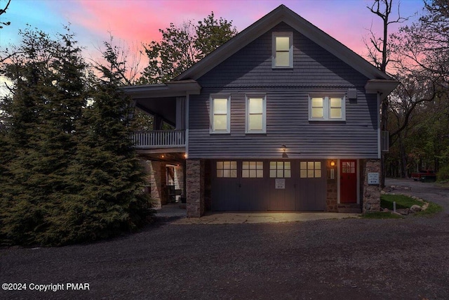 view of front of home featuring stone siding and driveway