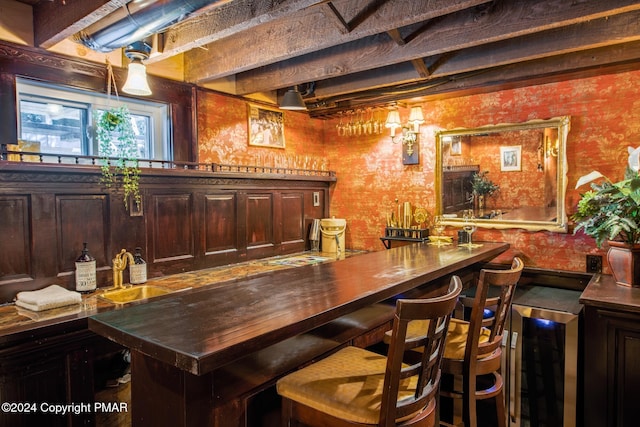 bar with wallpapered walls and wet bar