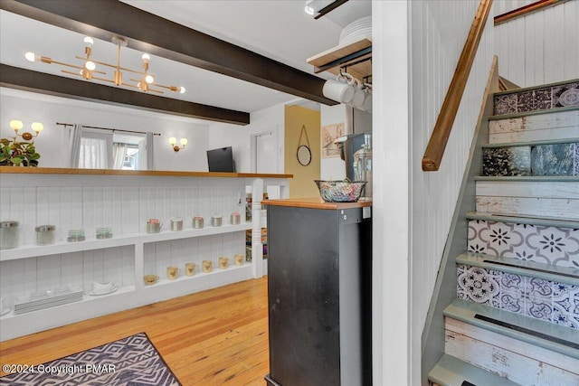 interior space featuring beam ceiling and wood finished floors