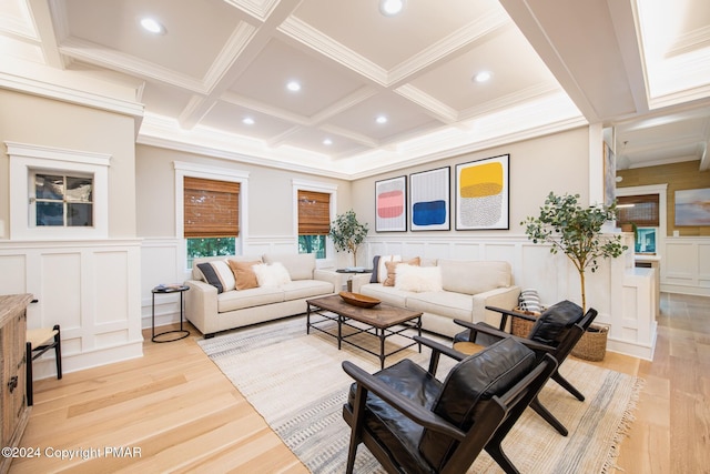 living area with ornamental molding, coffered ceiling, light wood-style flooring, and beam ceiling