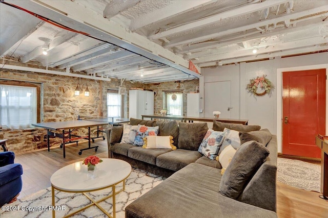 living room featuring beamed ceiling and light wood-type flooring