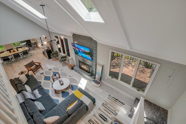 171 Flintlock Trl, Pocono Pines, PA 18350 - living room featuring a skylight, a fireplace, high vaulted ceiling, healthy amount of natural light, and beam ceiling