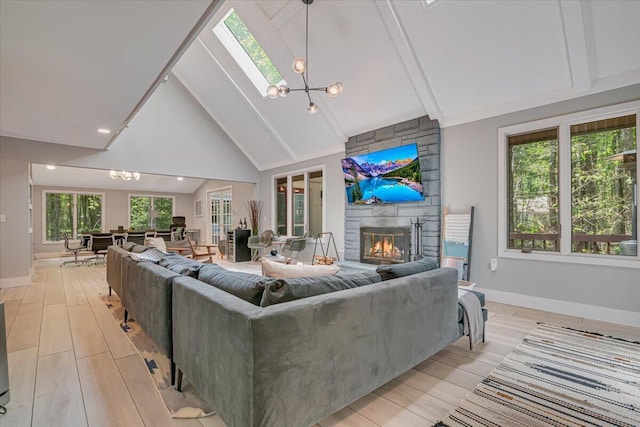 171 Flintlock Trl, Pocono Pines, PA 18350 - living area featuring a skylight, beamed ceiling, light wood-style floors, a stone fireplace, and baseboards