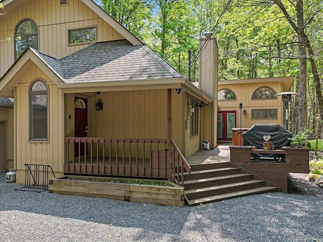 171 Flintlock Trl, Pocono Pines, PA 18350 - rustic home featuring a shingled roof, french doors, and a chimney