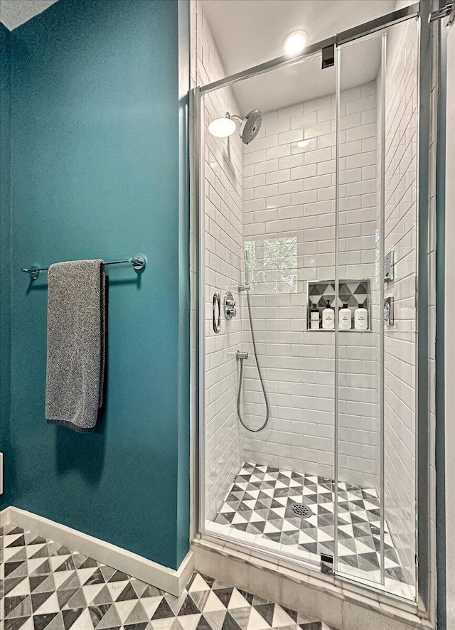 171 Flintlock Trl, Pocono Pines, PA 18350 - bathroom featuring a stall shower, baseboards, and tile patterned floors
