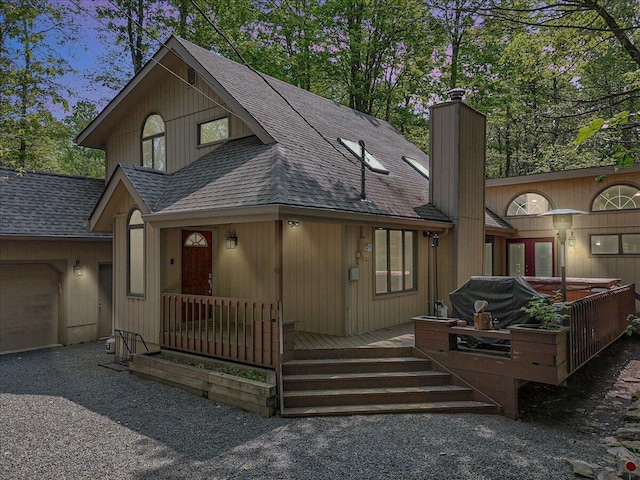 171 Flintlock Trl, Pocono Pines, PA 18350 - rustic home with roof with shingles, a garage, a chimney, and a wooden deck