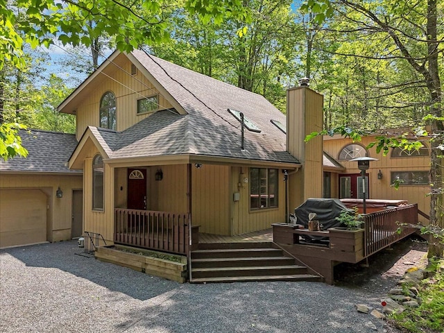 171 Flintlock Trl, Pocono Pines, PA 18350 - rustic home with roof with shingles, an attached garage, a chimney, and covered porch