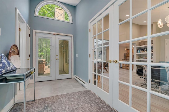 171 Flintlock Trl, Pocono Pines, PA 18350 - doorway featuring french doors, a baseboard heating unit, a chandelier, and a towering ceiling