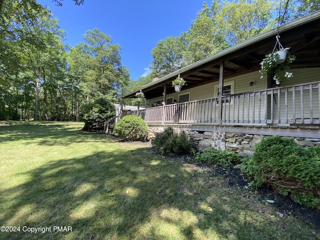 view of home's exterior with covered porch and a lawn