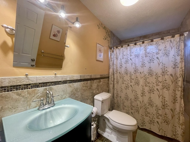 5144 Hounds Ear Rd, Tobyhanna, PA 18466 - bathroom with vanity, a textured ceiling, a wainscoted wall, toilet, and tile walls