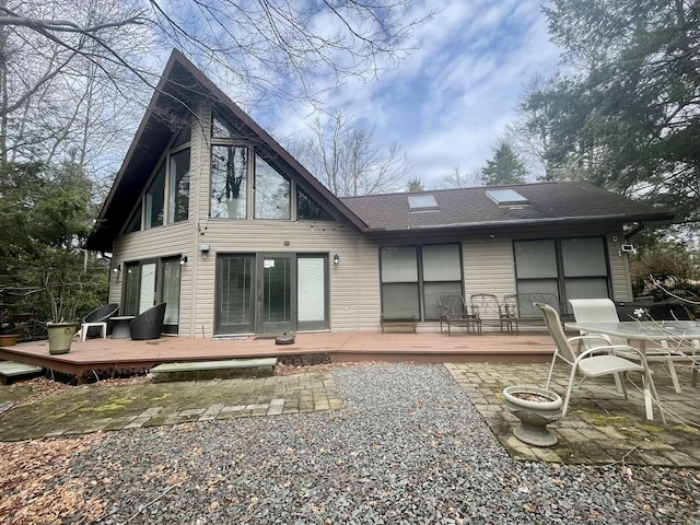 5144 Hounds Ear Rd, Tobyhanna, PA 18466 - back of house featuring roof with shingles, a wooden deck, and a patio area