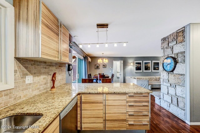 kitchen with tasteful backsplash, open floor plan, a peninsula, hanging light fixtures, and stainless steel dishwasher