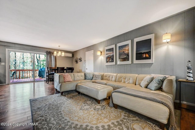 living room featuring wood finished floors and an inviting chandelier