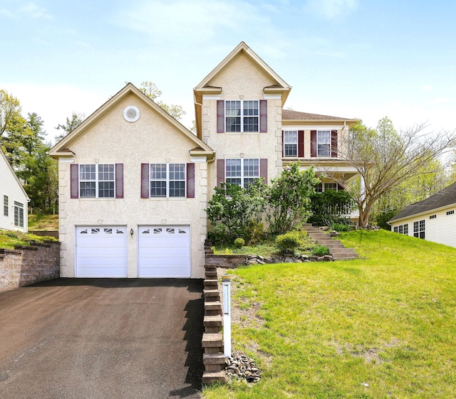 3185 Pine Valley Way E, Stroudsburg, PA 18302 - traditional-style home featuring a front lawn, stucco siding, stairs, an attached garage, and driveway