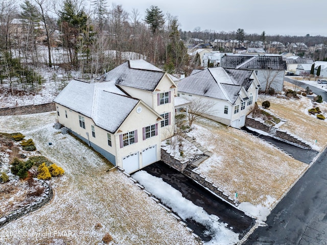 snowy aerial view with a residential view