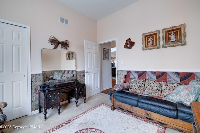 living area featuring carpet flooring and visible vents