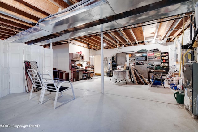 unfinished basement featuring a workshop area