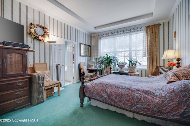 carpeted bedroom with a raised ceiling and wallpapered walls