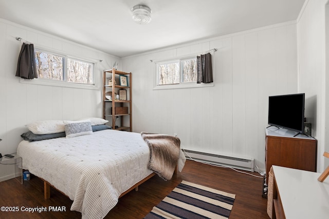 bedroom featuring dark wood finished floors and baseboard heating