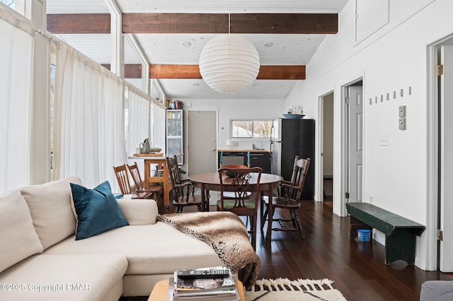 living area with dark wood-style floors and vaulted ceiling with beams