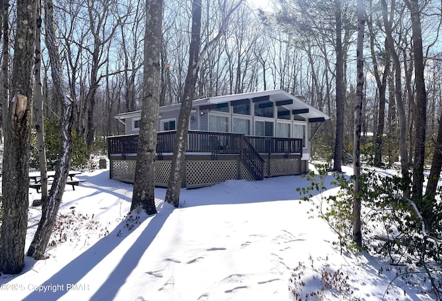 view of front of home featuring stairs and a deck