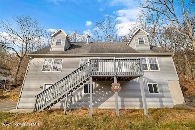 rear view of property with stairs and a wooden deck