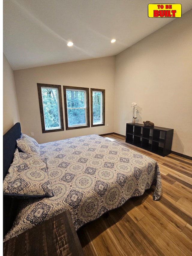 bedroom featuring recessed lighting, lofted ceiling, and wood finished floors