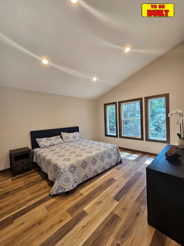 bedroom featuring recessed lighting, wood finished floors, baseboards, and vaulted ceiling