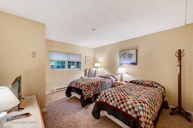 bedroom with carpet, a baseboard heating unit, and baseboards