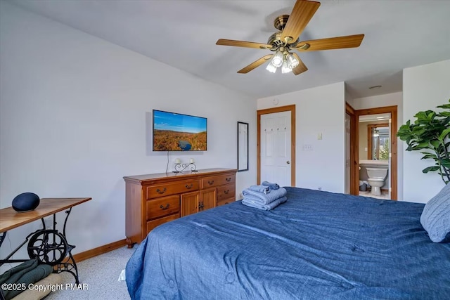 bedroom featuring connected bathroom, a ceiling fan, and baseboards