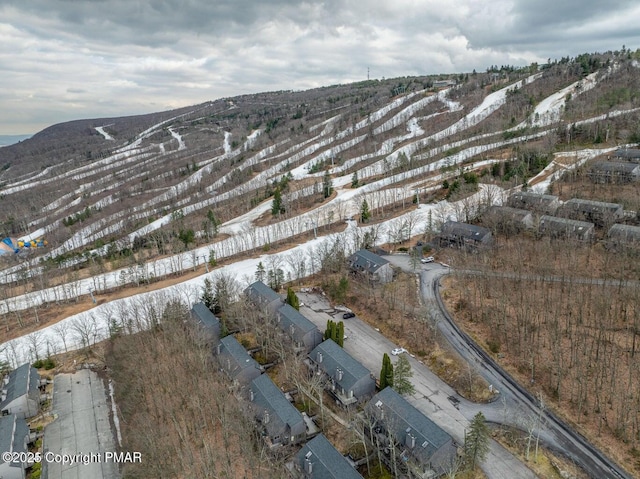 snowy aerial view featuring a mountain view