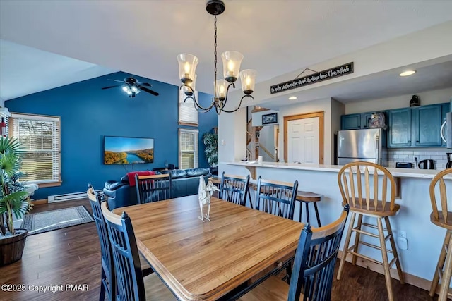 dining room featuring a baseboard radiator, dark wood-type flooring, ceiling fan with notable chandelier, vaulted ceiling, and recessed lighting