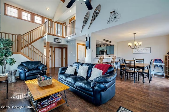 living room featuring recessed lighting, ceiling fan with notable chandelier, a high ceiling, wood finished floors, and stairway