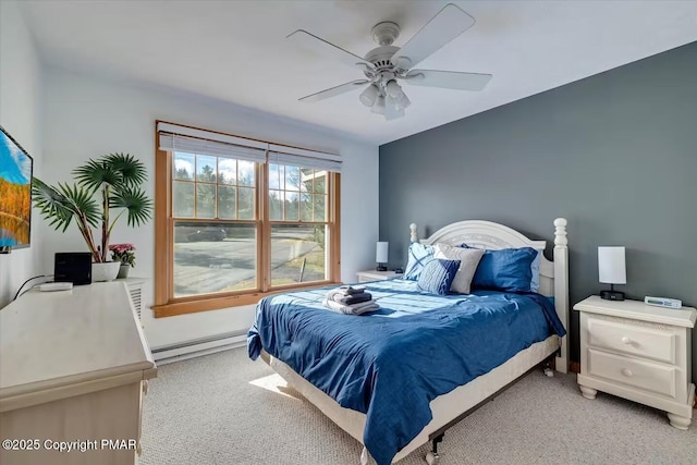 bedroom with a ceiling fan, light carpet, and baseboard heating